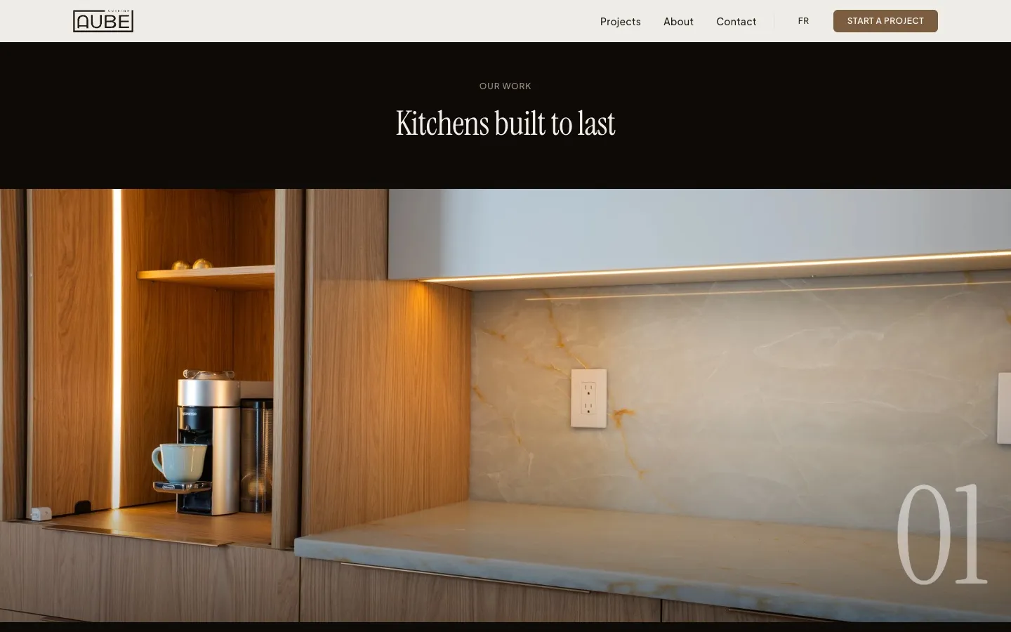 The projects section of the Cuisine Aube site: the heading Kitchens built to last over a full-width photo of a wood and onyx kitchen